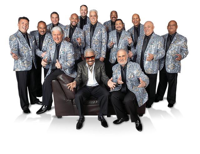 A band of musicians in matching suits